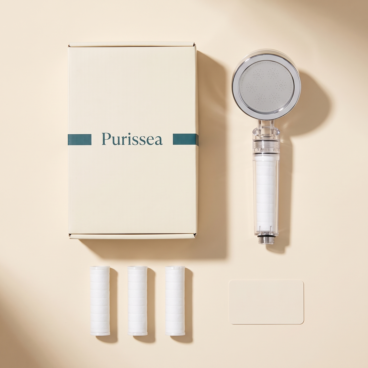Contenu du coffret Purissea : pommeau, 3 filtres de rechange et carte